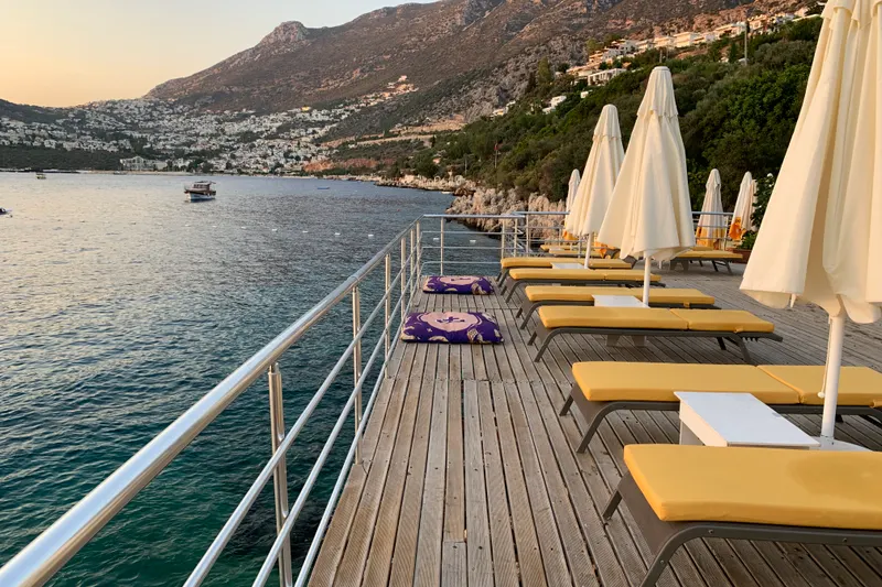 An inviting terrace of a Kalamar vs Kızıltaş villa with panoramic views of Kalkan Bay and surrounding landscapes.