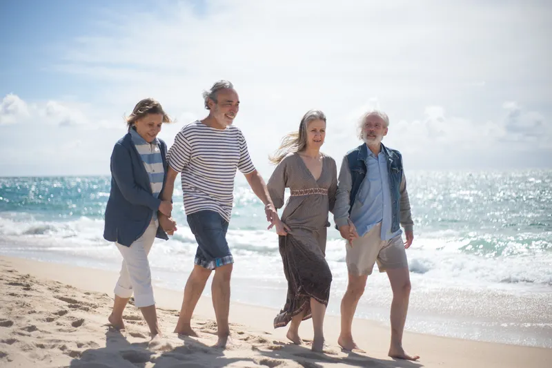 An engaging image illustrating the daily life of retirees in Alicante vs Benidorm retirement, highlighting public transport and social activities.