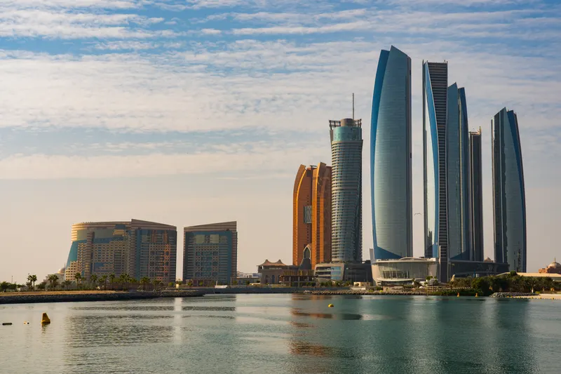 A spacious living room in an AED 3 million Abu Dhabi property highlighting modern design and waterfront views.