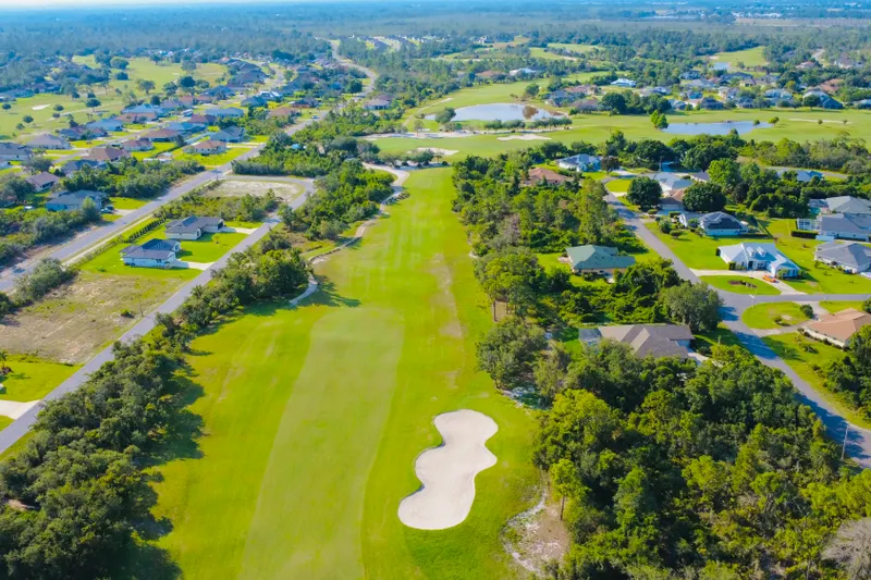 Aerial view of Algarve golf-front property premium highlighting the proximity to the golf course and scenic landscapes