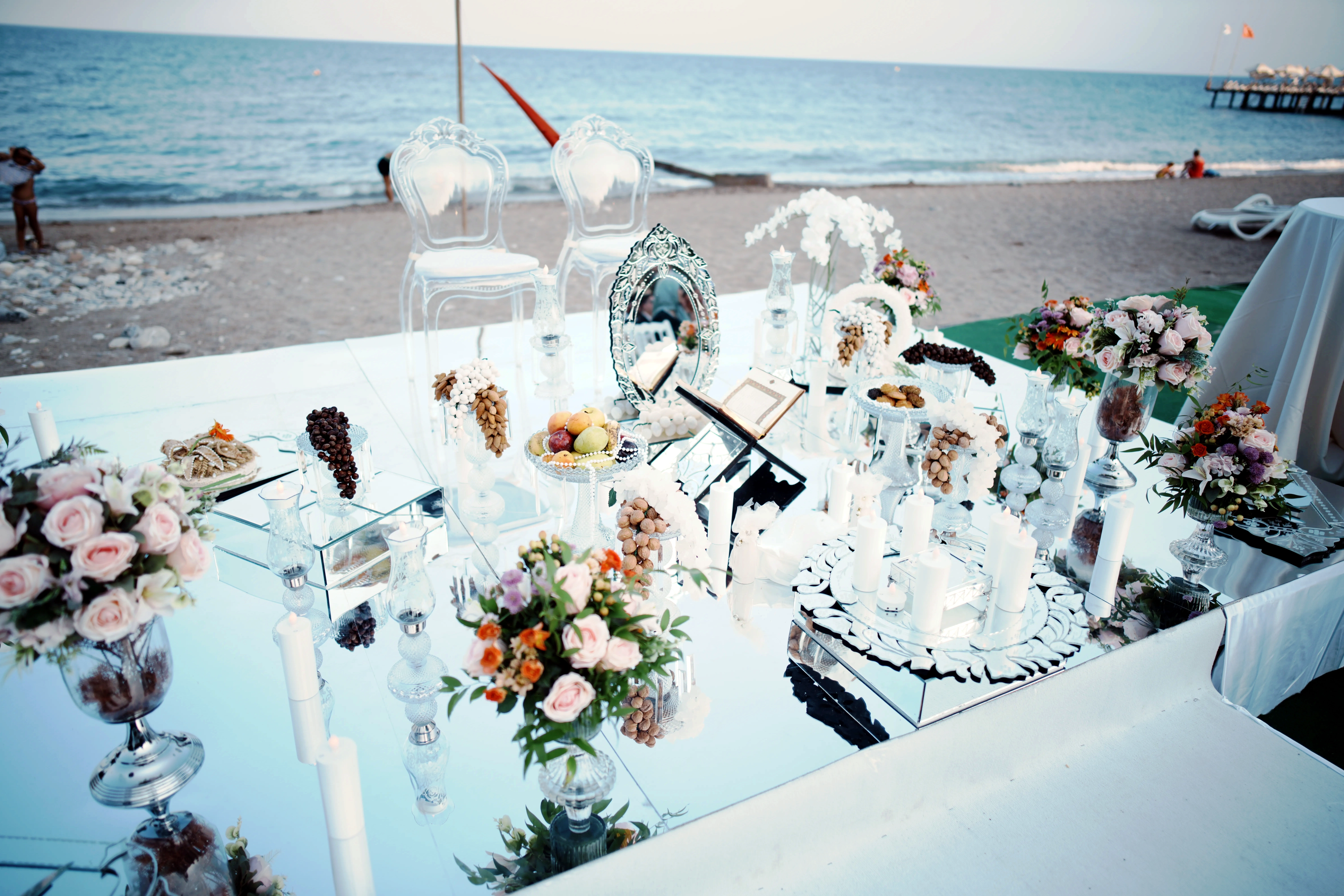 Persian Sofreh Aghd symbolic items including mirror candelabras and Seven Seens arranged by Ramarossi